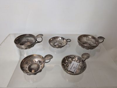 six silver plated bowls and spoons on a glass table