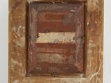 an old wooden picture frame sitting on top of a white wall