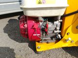 a small engine on the back of a yellow truck