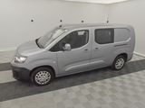 a silver van parked in a room with a checkered floor