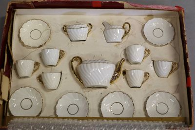 a box with a set of cups and saucers in it