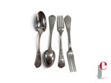 three spoons and a fork on a white surface