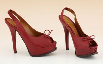 une paire d'escarpins rouges avec un nœud au talon