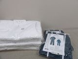 a pile of clothes sitting on a bed next to a pillow