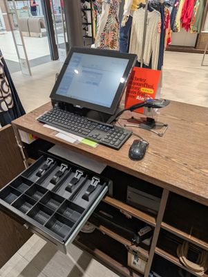 a laptop computer sitting on a desk in a store