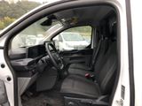 the interior of a white truck with the door open and the driver ' s seat down
