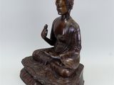statue of a seated buddha on a lotus flower base