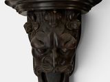 a close up of a lion head on a wall mounted on a white wall