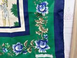 green and blue silk scarf with blue and white flowers on it