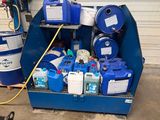 a blue container filled with blue and white containers next to a blue barrel