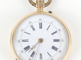 a gold pocket watch with roman numerals on the face