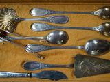 several spoons and spoon spoons are in a box with a spoon and spoon rest