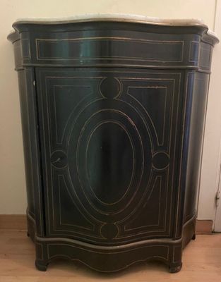 a black cabinet with a marble top on a wooden floor