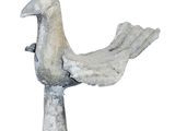 a statue of a bird on a pedestal on a white background