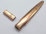 an image of a knife and a bullet on a white surface