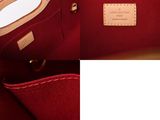 the inside of a red purse with a leather handle
