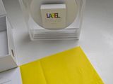a box that has a label on it and a yellow piece of paper in it