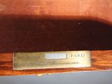a close up of a wooden shelf with a label on it