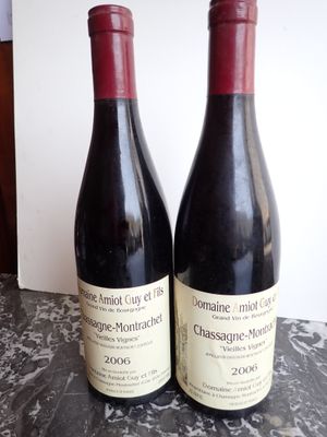 two bottles of wine sitting on a marble table