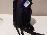 a small black backpack with a blue tag on it