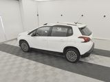 the white car is parked in the garage on the checkered floor