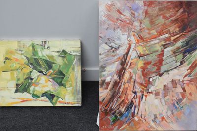 two paintings of different colors and shapes are on the floor