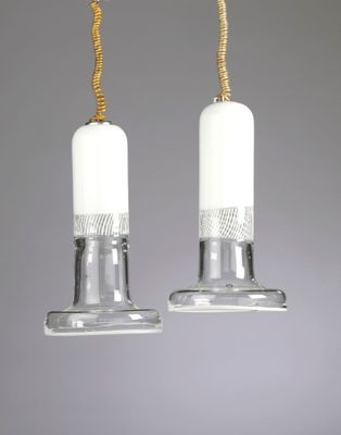 a pair of hanging glass candles on a rope