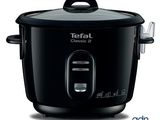 black electric rice cooker with lid open on a white background