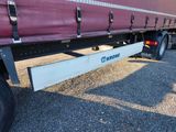 a semi truck with a flat bed on the back of it