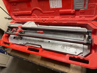 an image of a red tool box with a stapler and a stapler in it