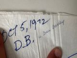 a hand holding a piece of paper that has writing on it