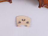 a violin with a piece of wood on the back of it