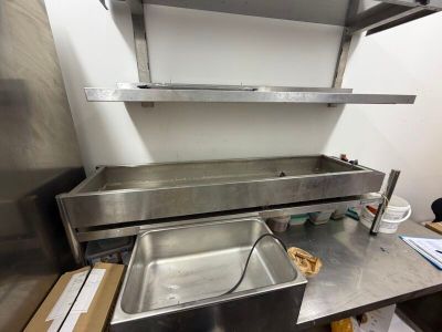 un évier en acier inoxydable au milieu d'une cuisine