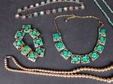 several pieces of jewelry including a necklace, bracelet, and broochet