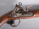 a close up of a gun on a table with a white background