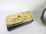 a gold bar and a small mirror on a table