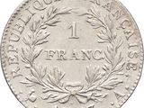 a close up of a coin with a wreath on it
