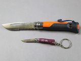 a knife and a keychain sitting on a table