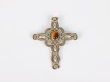 a close up of a cross with a stone in the center