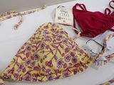 a yellow and pink bikini and a red bra