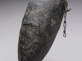 a close up of a sculpture of a rock with a chain around it