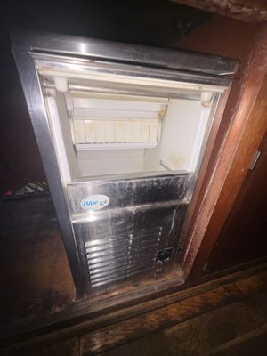 a small refrigerator in the corner of a room
