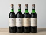 trois bouteilles de vin sont alignées sur une table en bois
