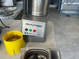 a blender sitting on a counter with a yellow cup next to it