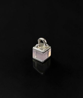 a close up of a small metal object on a black surface