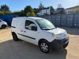 a white van parked in a parking lot next to a fence