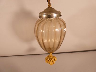 a glass lamp that is hanging from the ceiling