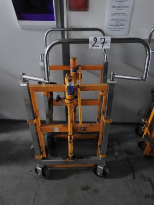 a metal cart with a handle on it in a room