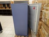 a refrigerator that is sitting in a room with boxes on the floor