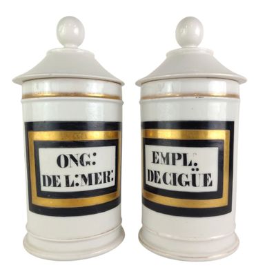 two white and gold canisters with black and white labels on them